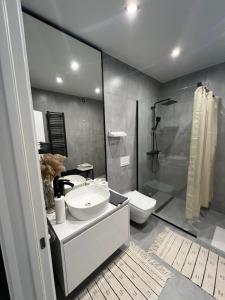 a bathroom with a sink and a toilet and a shower at New loft style apartment in Uzhhorod +28 photos