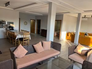 a living room with two couches and a dining room at Maison de Campagne in Dar SaÃ¯d Ben Hajj