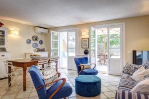 a living room with a table and blue chairs at Onde blu in Marina di Campo