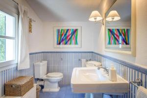 a blue and white bathroom with a toilet and a sink at Onde blu in Marina di Campo +25 photos