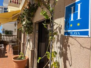 a sign on the side of a building that says playa at Hotel Macavi Playa in Rota