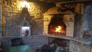 a brick oven with a fire in it at Insel Kaprije Nowak in Kaprije