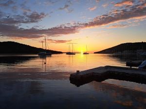 a sunset over a body of water with boats at Insel Kaprije Nowak in Kaprije +7 photos
