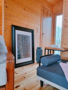 a living room with a couch and a table at 307 Tiny Elbhouse in Bleckede
