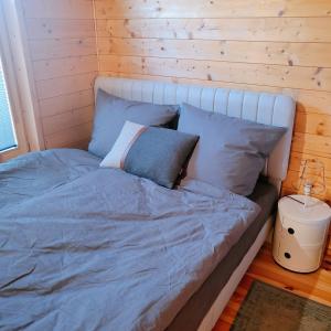 a bed with blue sheets and pillows in a room at 307 Tiny Elbhouse in Bleckede +18 photos