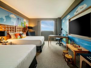 a hotel room with two beds and a flat screen tv at Pullman Sao Paulo Guarulhos Airport in Guarulhos +37 photos