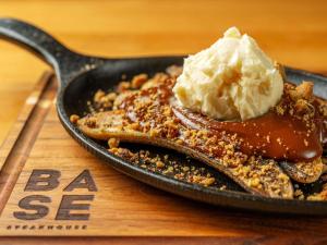 a skillet with a desert with a scoop of ice cream at Pullman Sao Paulo Guarulhos Airport in Guarulhos