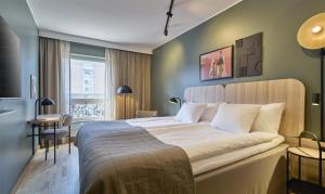 a bedroom with a large bed in a room at Scandic Malmen in Stockholm