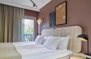 a bedroom with a large white bed with a window at Scandic Malmen in Stockholm