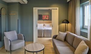 a living room with a couch and a bed at Scandic Malmen in Stockholm