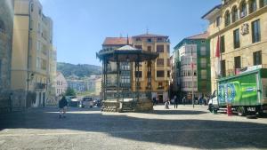 a street with a tower in the middle of a city at KIKU Apartments II in Bermeo