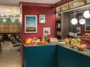 a restaurant with a counter with fruit on it at ibis Styles Paris Nation Cours de Vincennes in Paris
