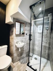 a bathroom with a shower and a toilet and a sink at Bee Stays - Rostherne House in Warrington +22 photos