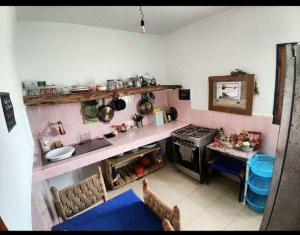 a kitchen with a stove and a table in it at Hippie Chic - Room La Dune in Sidi Kaouki