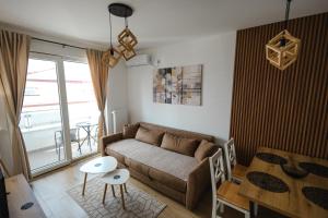 a living room with a couch and a table at Apartman Anika Banja Koviljača in Banja Koviljača