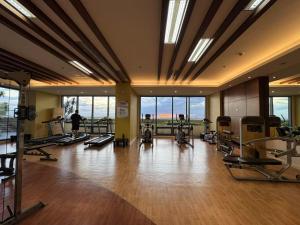a gym with a lot of treadmills and machines at Sunset House Roxas Bay in Manila