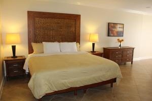 a bedroom with a large bed with two night stands at Divi Studio in Palm-Eagle Beach
