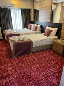 Postel nebo postele na pokoji v ubytování Nida Hotel Cıty Center