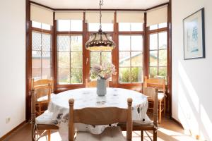 a dining room with a table with a vase of flowers at Ferienhaus May App 1 in Sahrensdorf