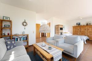 a living room with two couches and a coffee table at Ferienhaus May App 1 in Sahrensdorf