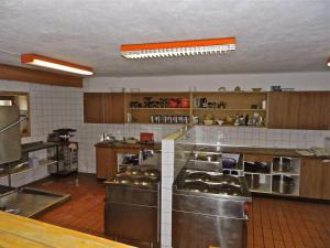a large kitchen with lots of stainless steel appliances at Maison St-Pierre in Bourg-Saint-Pierre