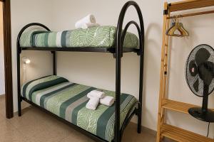 a bunk bed room with two bunk beds and a fan at Casa vacanze Sardegna, Torre dei Corsari Costa Verde in Torre Dei Corsari +22 photos