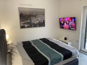 a bedroom with a bed and a tv on the wall at Villa Aldina Apartment 2 in Bihać +24 photos