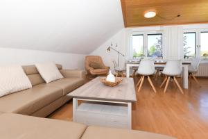a living room with a couch and a table at Ferienwohnung Rotbuche in Westerholt