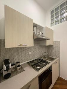 a kitchen with a stove and a counter top at Violet House in Palermo