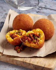 three food items sitting on a cutting board at Violet House in Palermo +1 photo