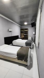 Postel nebo postele na pokoji v ubytování Hotel Curitiba Campo Comprido