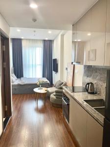 a kitchen and living room with a couch and a table at Vinhome Ocean Park 1 Gia Lâm, Hà Nội Apartment in Gia Lâm Pho