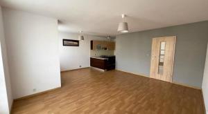 un soggiorno vuoto con pavimenti in legno e una cucina di Hidden Gem in Martinique a Case-Pilote