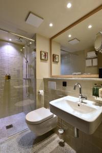 a bathroom with a sink and a toilet and a shower at Monbijou Hotel in Berlin
