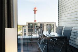 a table and chairs on a balcony with a view at Beltblick in Marienleuchte
