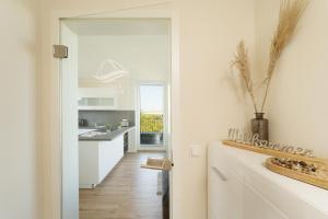 a kitchen with white cabinets and a counter top at Beltblick in Marienleuchte +39 photos