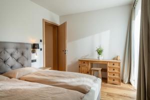 Un dormitorio con una cama y una mesa con un jarrón. en Chalet Magdalena, en Kirchberg in Tirol