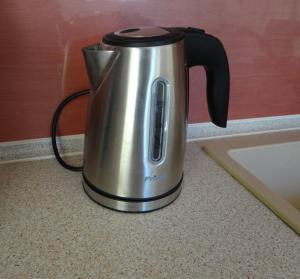 a tea kettle sitting on a counter next to a sink at Kalogeriko in Polychrono