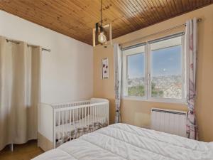 Le BernardにあるMaison pour 2 adultes et 2 enfants avec jardinのベビーベッドと窓付きのベッドルーム1室