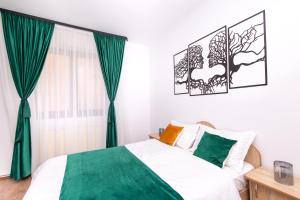 a bedroom with a bed with green curtains at Casa Walter Ultracentral - Terasă Privată in Curtea de Argeş