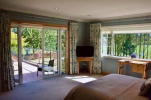 a bedroom with a bed and a sliding glass door at Woodlands Green in Mitcham