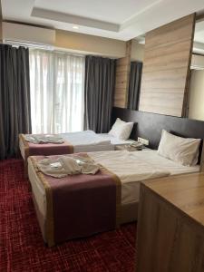 Postel nebo postele na pokoji v ubytování Nida Hotel Cıty Center