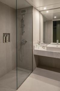 a bathroom with a shower and a sink at Amalia Hotel Delphi in Delfoi