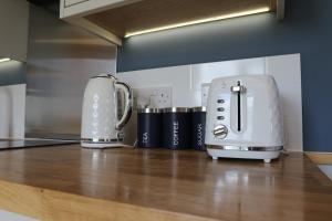 two toasters sitting on a counter in a kitchen at Oak Moor Shepherd Hut - Brecon Beacons, LD3 7TD in Tal-y-llyn