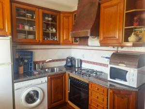 a kitchen with a sink and a stove top oven at CASA MILFONTES by Stay in Alentejo in Vila Nova de Milfontes