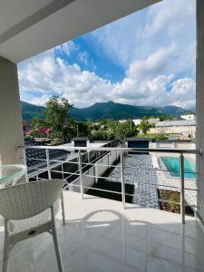 a balcony with a view of a pool and mountains at Gabala Breeze Villa in Gabala