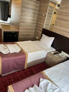 Postel nebo postele na pokoji v ubytování Nida Hotel Cıty Center
