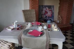 a table with two plates of food on it at Le Clos Saint Jean in Sainte-Honorine-des-Pertes