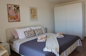 a bedroom with a bed with towels on it at Horizont view apartment in Pula