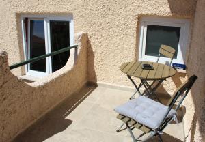 a small balcony with a table and a chair at Horizont view apartment in Pula
